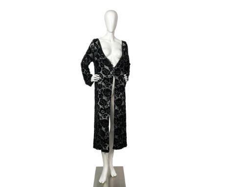 A dazzling black long sleeved sheer cardigan with a floral beaded velvet pattern. Bust: 20"W. Shoulder width: 20"W. Sleeve le