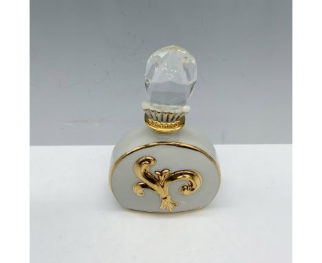 Spectacular container used to store fragrance that has a gilt design similar to the Fleur de Lis and is topped with a Swarovs