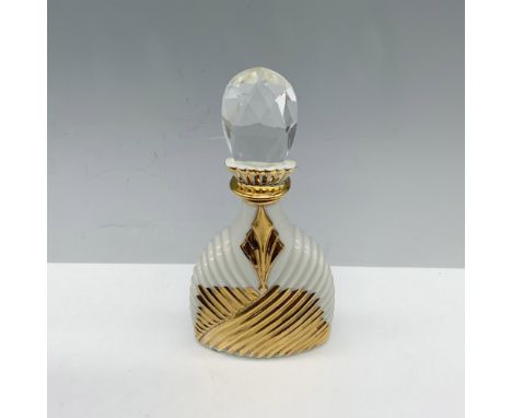Lovely container used to store fragrance that has a gilt design over the mold of the body and is topped with a Swarovski crys