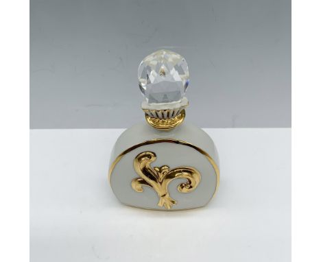 Amazing container used to store fragrance that has a gilt design similar to the Fleur de Lis and is topped with a Swarovski c