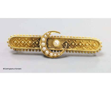   A late Victorian yellow metal and seed pearl set bar brooch, with crescent motif, 46mm, gross weight 5.2 grams.