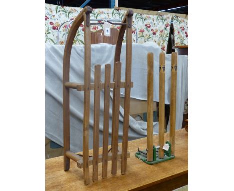   A vintage sled, a set of practise cricket stumps on sprung cast iron base