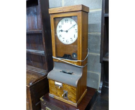   A vintage oak-cased electric wall factory time recorder clock, circa 1930,having circular painted dial and bearing plaque i