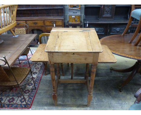   A Victorian pine clerk's desk,with sloping top, side flaps and brass inkwell, on turned supports, length 62cm, depth 56cm, 