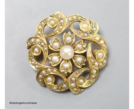   A late Victorian 15ct and seed pearl circular cluster pendant brooch, 25mm,gross weight 5.7 grams.