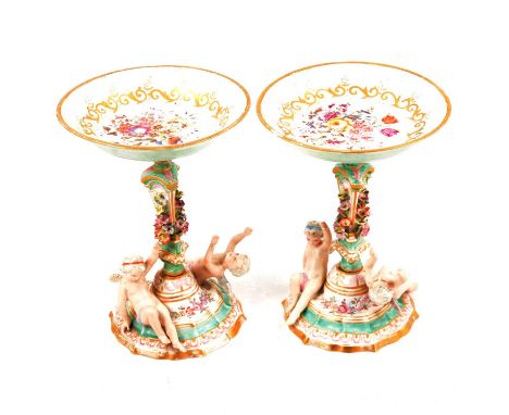 Pair of Meissen style porcelain tazza, the pan tops painted with floral sprays, architectural and floral columns, the bases m