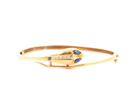 A gemset snake half hinged bangle, the snake head set with sapphires and diamonds, in unmarked yellow metal, with safety clip