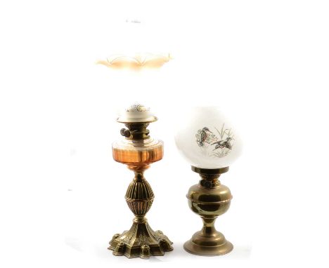 Victorian style brass oil lamp, Gothic style spreading base with swollen knop column, supporting a peach glass coloured reser
