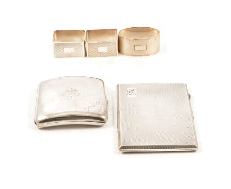 Two silver cigarette cases and three napkin rings, a silver engine turned cigarette case, Birmingham 1946, 12x8.5cm; a plain 