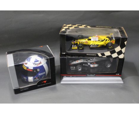 Two Mini Champs diecast Formula 1 racing cars and McLaren Mercedes Team Edition helmet