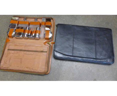 A gentleman's travel case, hair brushes, comb, jars for soap, cream, scissors, etc., in pigskin, and a black leather document