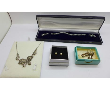 A silver tennis bracelet, silver earrings with PMB makers mark, silver and marcasite necklace and a pair of 9ct gold and pear