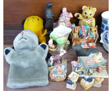 Two resin figures of otters, eight Peter Jones resin comical cat and other ornaments, a Sandland Teddy money bank, a Wade Nat