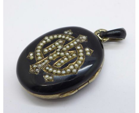 A continental silver, enamel and pearl set locket with control marks, width 28mm 