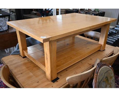 A golden oak coffee table, with magazine shelf beneath 76cm x 46cm x 120cm