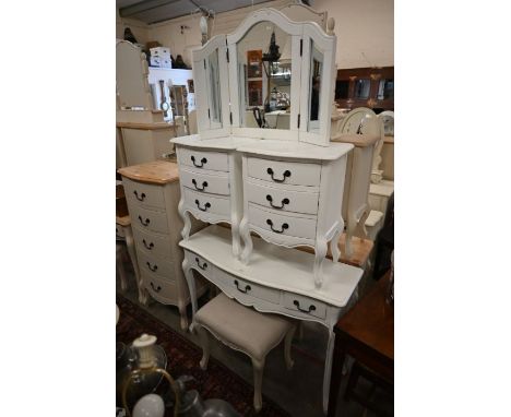 A white painted bedroom set comprising a three drawer side table, a pair of three drawer bedside chests, a dressing mirror an