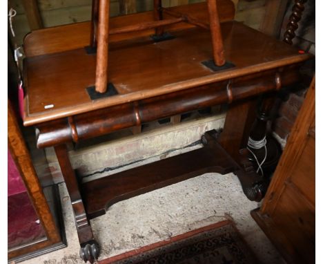 A Victorian mahogany console table, cushion moulded frieze fitted with two drawers, rectangular supports standing on scroll f