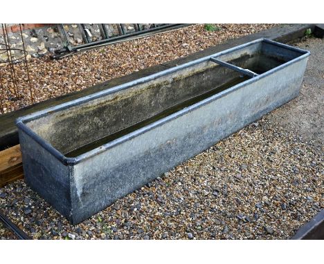 A large galvanized water trough (49cm w x 43cm d x 245cm l)