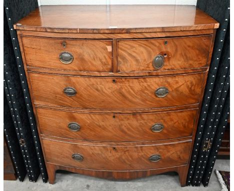 A Georgian mahogany bowfront chest of two short over three long graduated drawers, raised on splayed bracket feet,