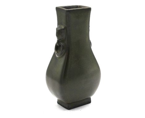 A Chinese ceramic slab-sided teadust vase, late Qing dynasty or Republic, with moulded mask and ring neck "handles", indistin