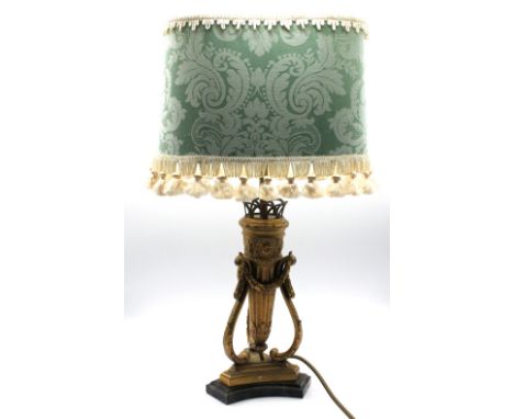 An early 20th century Regency style ormolu gilt metal lamp base, of elaborate shape with scrolled supports , banner detail an