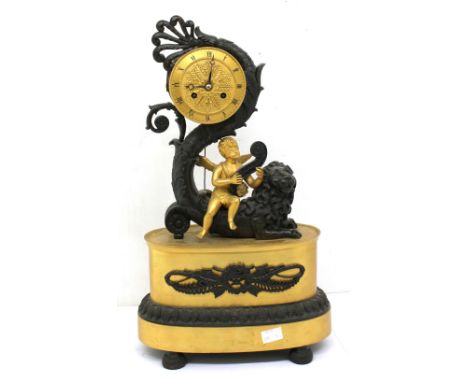 A 19th century French Empire period sculptural ormolu/bronze mantel clock modelled as a cherub riding on a Merlion with uplif