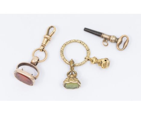 A collection of three seals to include a gilt metal 19th century seal set with an intaglio green hard stone, engraved with fl