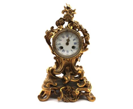 Mid 19th century French 8 day mantel clock with gilt ormolu case, enamelled dial with Arabic and Roman numerals, minute hand 