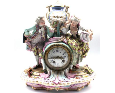 A German porcelain figural clock group depicting a gentleman artist showing his lady companion a miniature portrait. Both are