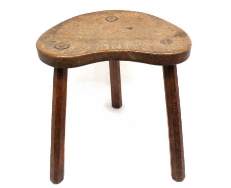 Workshop of Robert 'Mouseman' Thompson of Kilburn: a Yorkshire oak kidney shaped stool, on three legs, seat carved with tradi