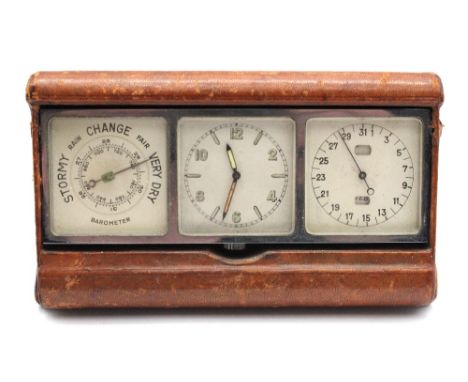 An Art Deco travelling desk-top timepiece and barometer, all folding in leather case with cover over glazed and chromed dials