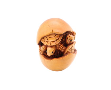 A 20th century Japanese light hardwood netsuke in the form of baby turtles hatching from an egg, signed Yusumatsu, approx. 4.