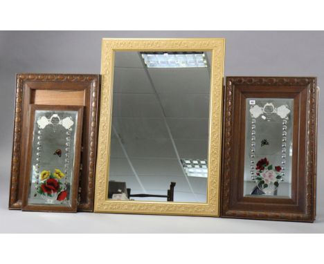 A pair of floral decorated rectangular wall mirrors each inset with a bevelled plate, &amp; in a carved oak frame, 33” x 20½”