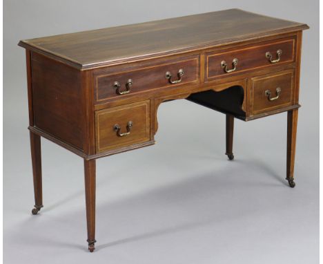 An Edwardian inlaid mahogany dressing table with moulded edge to the plain rectangular top, fitted two long &amp; two short d