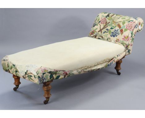 A late 19th century daybed with a scroll-end (requires upholstery), on four turned legs with ceramic castors, 72” long. 