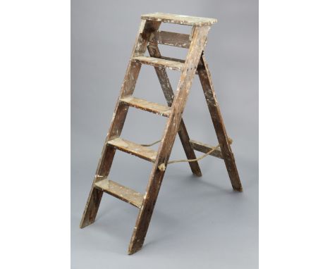 A vintage wooden four-rung folding step ladder, 52” high.