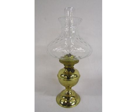 Brass oil lamp with clear glass chimney and shade