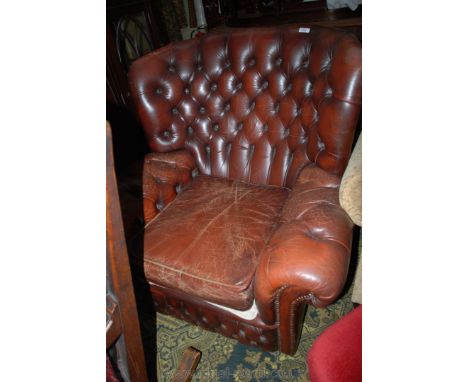 A reproduction Georgian style wide button upholstered Leather Armchair