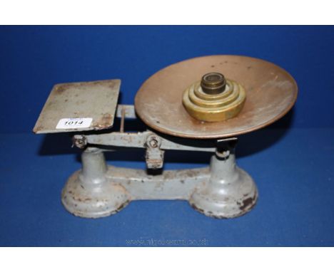 A painted cast Kitchen Scales with five weights.