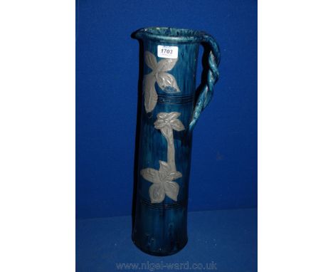 An unusual Art Nouveau ceramic Jug with applied pewter decoration, 47.5 cms tall, professionally restored to museum standard