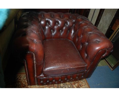 A reproduction Georgian style brown Leather button upholstered tub Armchair
