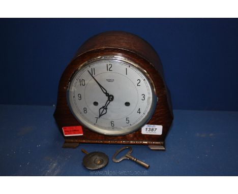 A Smith Enfield chiming Mantle Clock with key and pendulum.