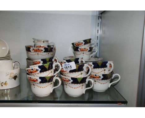 A Tea service for twelve by F.J.J. Milgrove in blue, green and amber coloured decoration