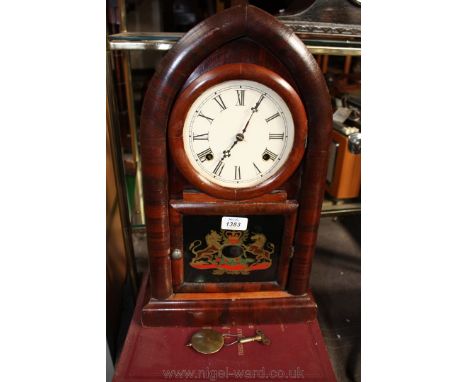 A chiming arched Bracket Clock with Armorial glass panel, with key and pendulum.