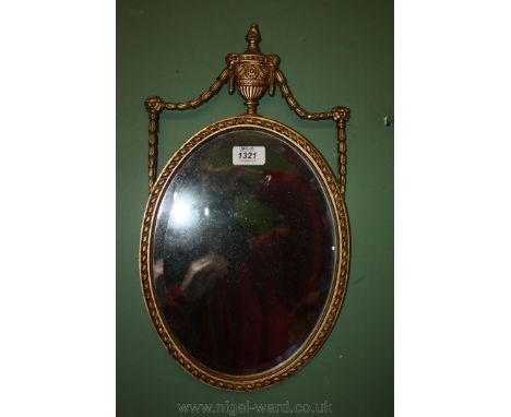 A small oval shaped gilt framed Wall Mirror with Greek urn detail to the top.