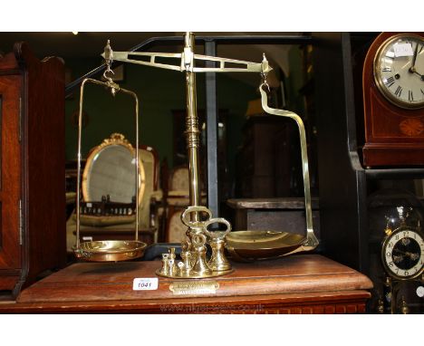 A Brass Scales with plaque for the Co-operative Wholesale Society, makers Balloon Street, Manchester, with eight weights