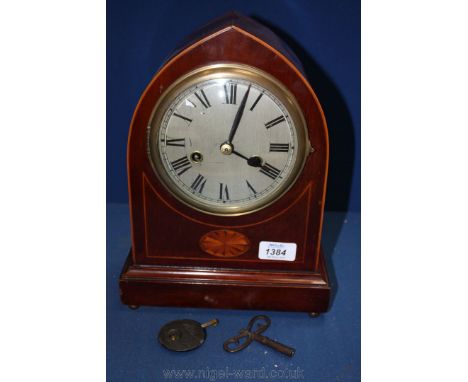 A chiming arched Bracket Clock with inlaid detail, key and pendulum.