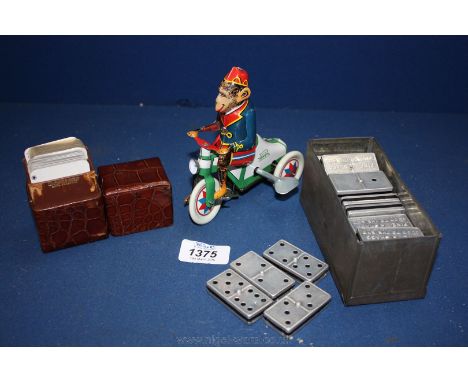 A set of metal covered Dominoes advertising Franklyns, a tin plate Monkey on a bike, Shag Tobacco with vintage leather case c