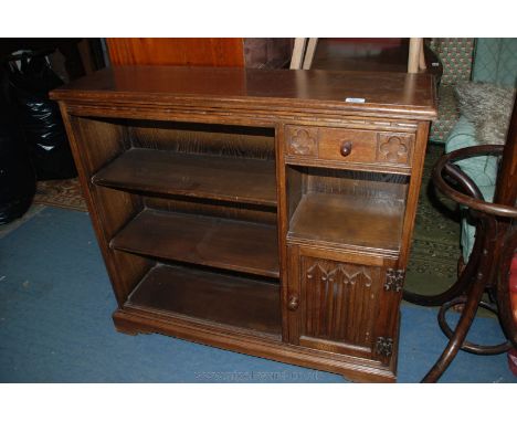 A Priory style modern Oak open Bookcase, having three shelves, single carved front drawer, over open short shelf in turn over