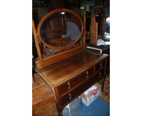 An Edwardian Mahogany Dressing Chest with oval mirror.